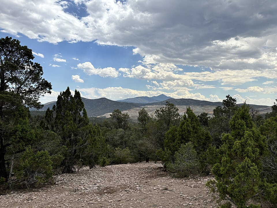Scenic view from Garnet Hill near Ely, White Pine County, Nevada with pink volcanic slopes, juniper trees, and high desert mountain horizon